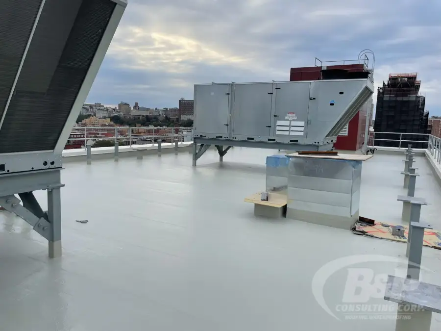 Light gray coated roof with rooftop HVAC units in Harlem