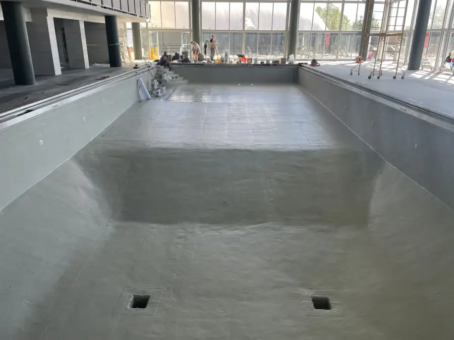Empty concrete swimming pool coated with gray waterproofing