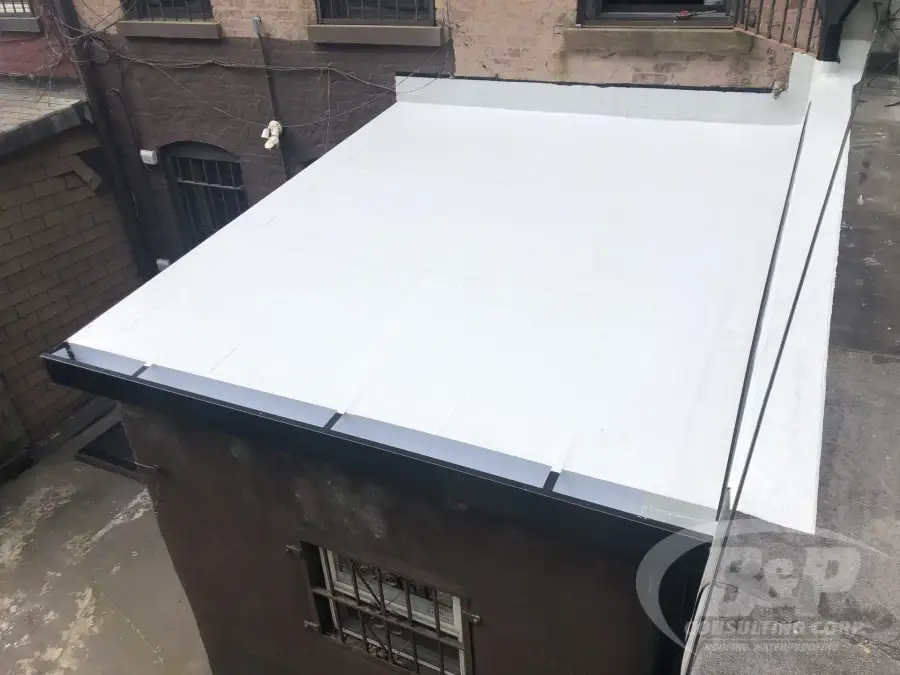 White setback roof with metal edge over a brick building